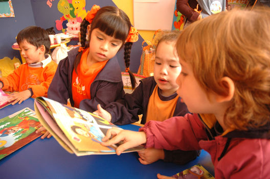 Niños residentes en el distrito de Los Olkivos leyendo unos cuentos