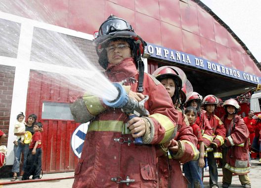 Miembros del cuerpo de bomberos sofocan las llamas de un incendio